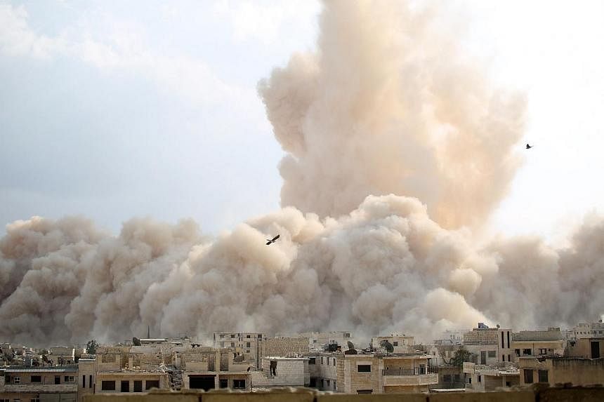 A picture taken on Oct 14, 2014 shows a large explosion allegedly hitting a Syrian army military outpost in the southern part of the city of Maarat al-Numan in the Idlib province.&nbsp;Syrian rebels led by Al-Qaeda loyalists launched a major assault 