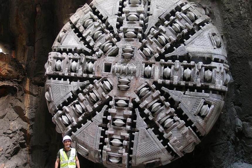 TNP reporter Benson Ang stands in front of Hillview Best, one of the tunnel-boring machines for the Downtown Line 2, on Aug 7, 2012. The Land Transport Authority is holding a number of rail road shows from November 2014 to January 2015 to give commut