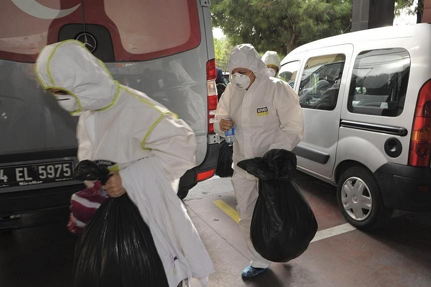 Members of the Turkey's disaster management agency (AFAD) carry bags from the Canadian Consulate in Istanbul on Oct 24, 2014.&nbsp;The Hungarian consulate in Istanbul on Monday became the sixth diplomatic mission in Turkey's largest city to report re