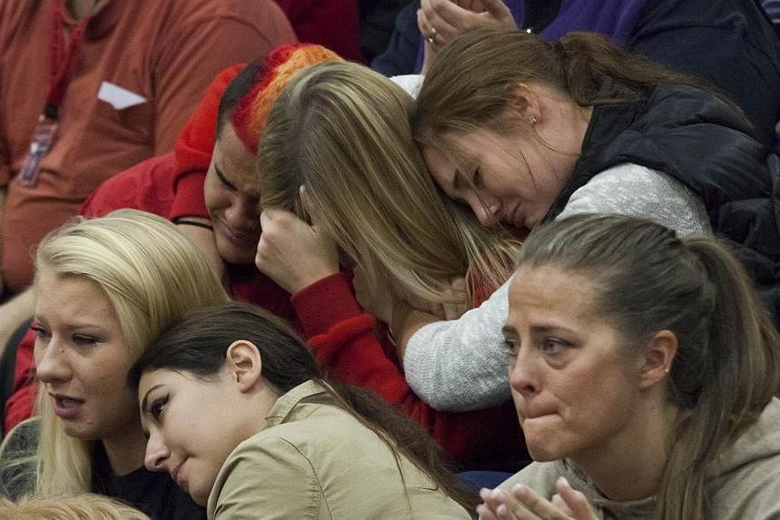 Members of the community and students grieve during a gathering at Marysville-Pilchuck High School on Oct 26, 2014 in Marysville, Washington. US teen Gia Soriano, who was fighting for her life after getting shot in the head during a shooting at the h
