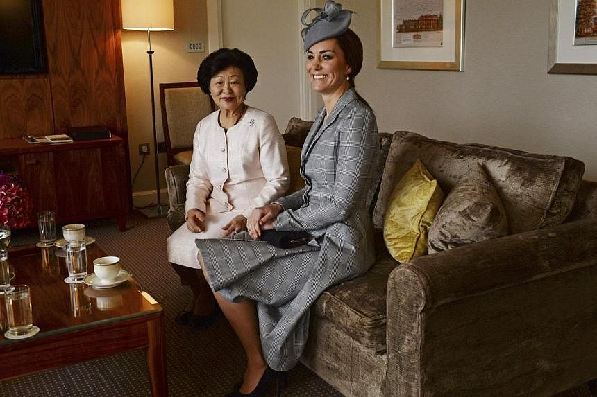 Britain's Catherine, Duchess of Cambridge (right) with Mary Chee, wife of the President of Singapore Tony Tan , after the Duchess and her husband Prince William greeted the President and his wife at the Royal Garden Hotel in London on Oct 21, 2014. -