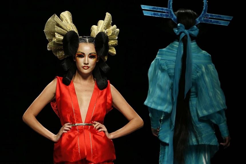 Models present creations at the MGPIN 2015 Mao Geping makeup trends launch at China Fashion Week in Beijing on Oct 27, 2014. -- PHOTO: REUTERS