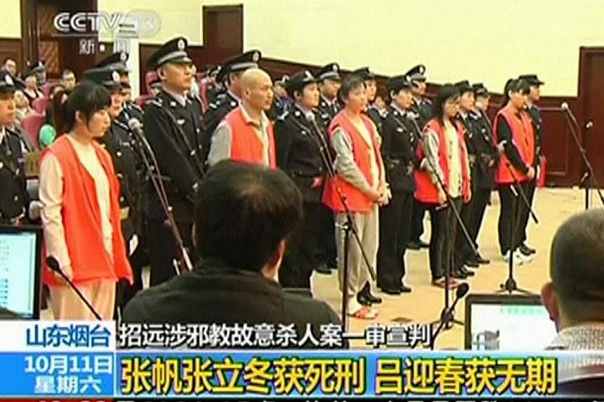 Defendants stand during their trial for the murder of a woman at a McDonald's restaurant after she apparently refused to join their religious group, in Yantai City, Shandong province on Oct 11, 2014 in this still image taken from video.&nbsp;China wi