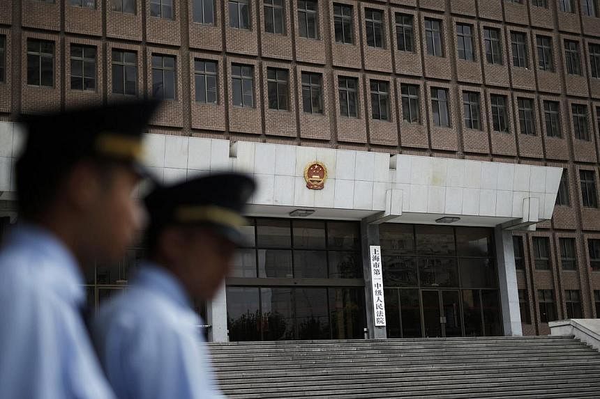 Police patrol outside the Shanghai No.1 Intermediate People's Court in Shanghai on Aug 8, 2014.&nbsp;The Chinese government is looking into abolishing the death penalty for nine of the 55 crimes that are currently punishable by death, state news agen