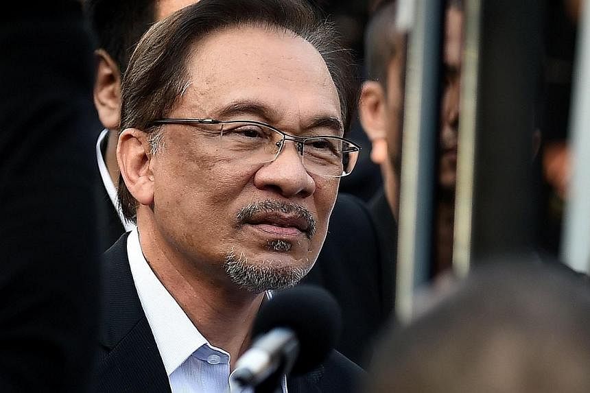 Malaysian opposition leader Anwar Ibrahim arrives at the court of appeals in Putrajaya, outside Kuala Lumpur on Oct 28, 2014. -- PHOTO: AFP