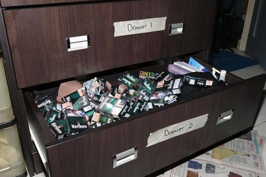 Contraband cigarettes stored in drawers in a HDB flat. 37 people were caught for storing and selling these duty-unpaid cigarettes to neighbourhood residents in the first nine months of this year. -- PHOTO: FACEBOOK/SINGAPORE CUSTOMS