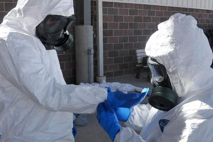 Soldiers go through protective suit training prior to their unit's deployment to Liberia in support of Operation United Assistance, the US military's response to the Ebola outbreak in West Africa. The Pentagon announced Oct 27, 2014 that all US troop