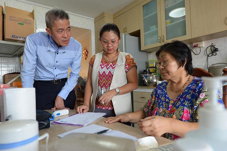 National Kidney Foundation chief executive Edmund Kwok and nurse Tracy Teo at the home of dialysis patient Yeo Thiam Keow, 61, a housewife. Mr Kwok regularly accompanies nurses and logistics staff when they visit patients' homes. Every week, he visit