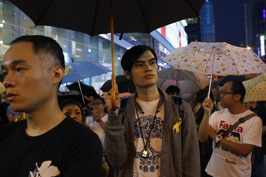 Pro-democracy protesters hold up umbrellas and as they take part in the one-month anniversary of the Occupy civil disobedience movement while blocking a main road at Mongkok shopping district in Hong Kong Oct 28, 2014. Nearly nine out of 10 Hong Kong