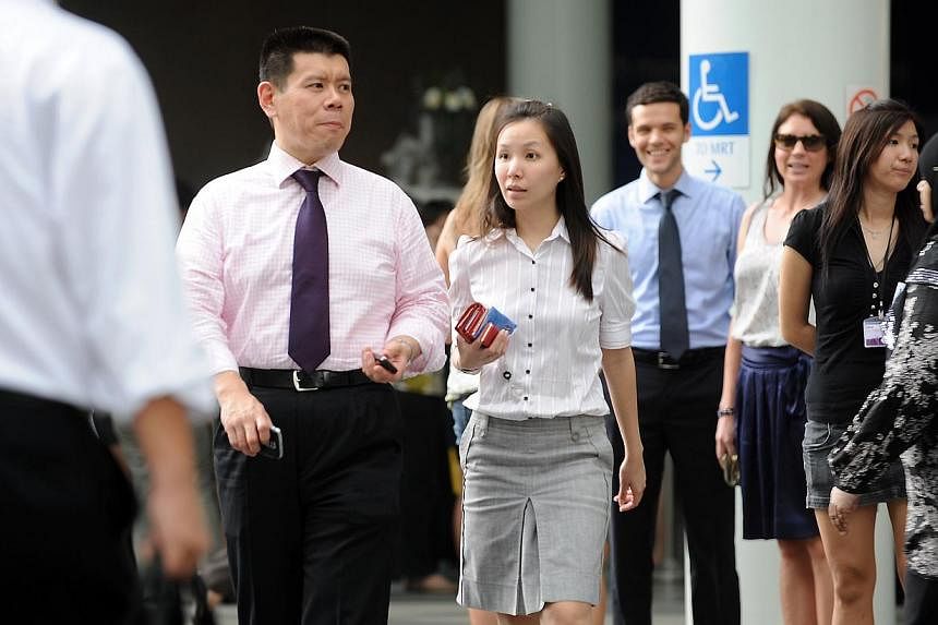 Office workers at Raffles Place, Singapore's Central Business District, during lunch hour. -- PHOTO: ST FILE&nbsp;