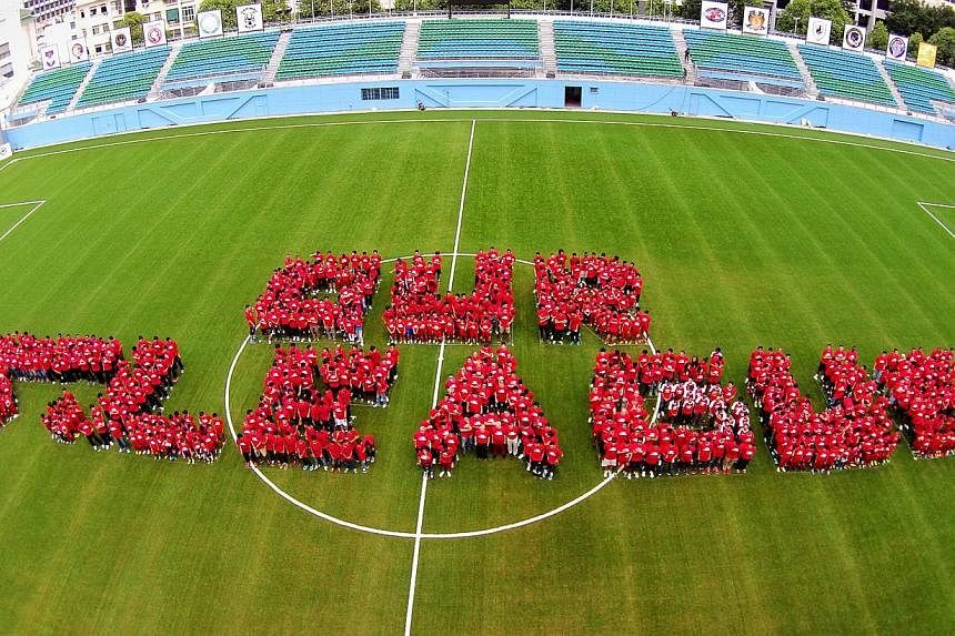 Over 700 S-League players, coaches, youth players and fans formed the words "Our S-League" to show their unity on the pitch during the S-League fanfare event held at the Jalan Besar Stadium on Feb 15, 2014. -- PHOTO: THE NEW PAPER