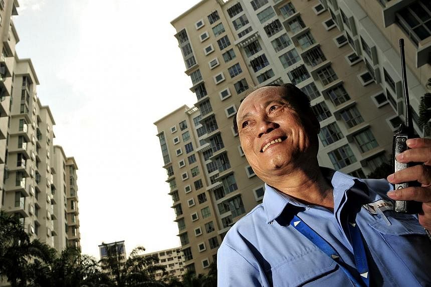Condominium security officer Lim Kiam Hoe, 59, a father of three, currently takes home about $1,400 a month. -- PHOTO: ST FILE