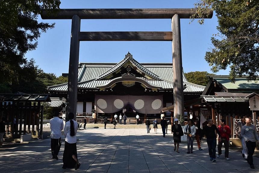 People visit the controversial Yasukuni shrine in Tokyo on Oct 17, 2014.&nbsp;Some members of an influential group that represents families of Japanese war dead are urging managers of a controversial Tokyo shrine to remove the names of 14 convicted w