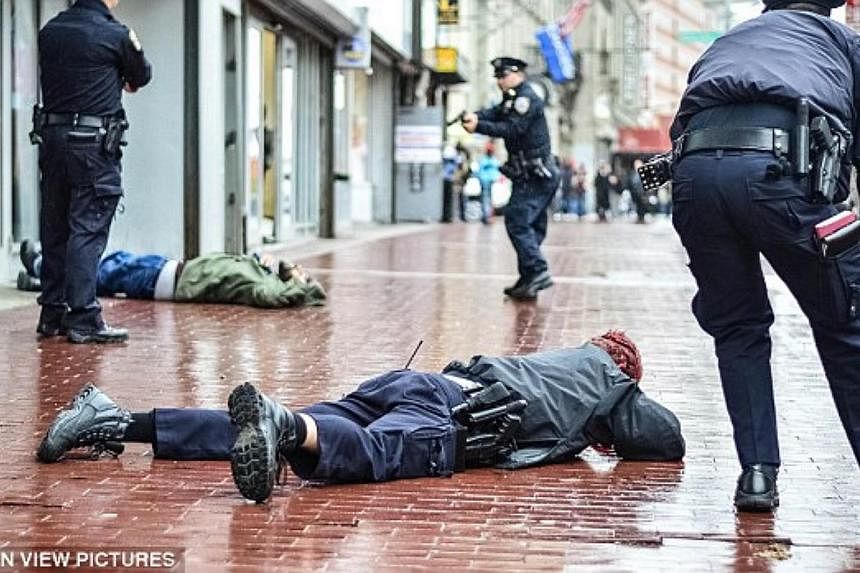 Officer Kenneth Healey lies on the ground with a wound to his head.&nbsp;Zale Thompson, who&nbsp;was shot by two officers after he attacked them with a hatchet,&nbsp;can be seen lying dead in the background.&nbsp;&nbsp;-- PHOTO: MOTION VIEW PICTURES