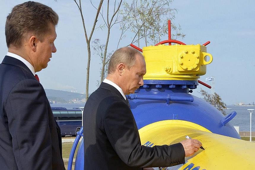 Russia's Prime Minister Vladimir Putin (right) and Gazprom CEO Alexei Miller attend a gas pipeline opening ceremony in Russia's far eastern city of Vladivostok, in this Sept 8, 2011, file photo.&nbsp;Ukraine and Russia were set on Wednesday to resume