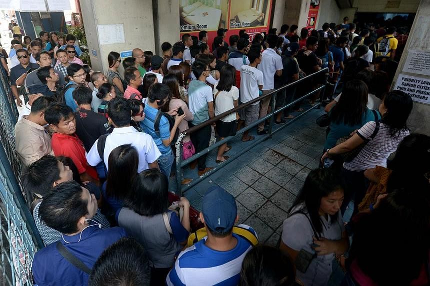 Commuters queuing to ride the Light rail transit in Quezon City suburban Manila, on Oct 10, 2014.&nbsp;Manila in the Philippines was the city where women were most in favour of single-sex transport, backed by more than nine in 10 women, or 94 per cen