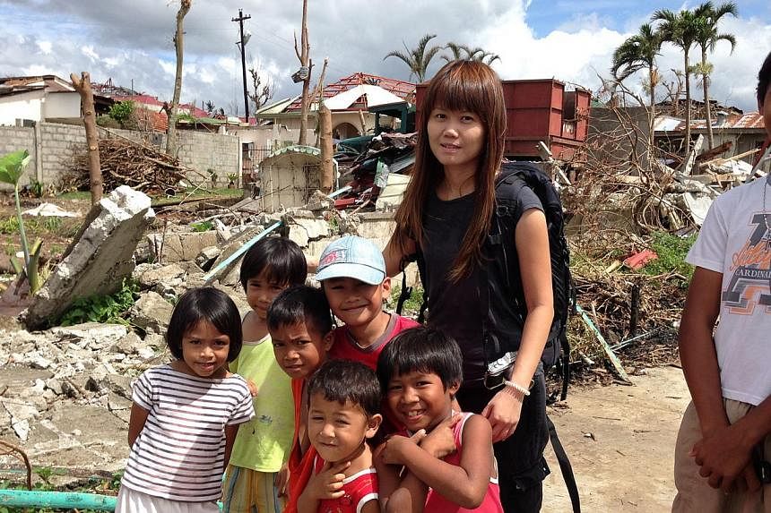 Straits Times correspondent Joyce Lim with young survivors of the devastating typhoon that struck the Philippines in 2013.&nbsp;-- PHOTO: ST FILE