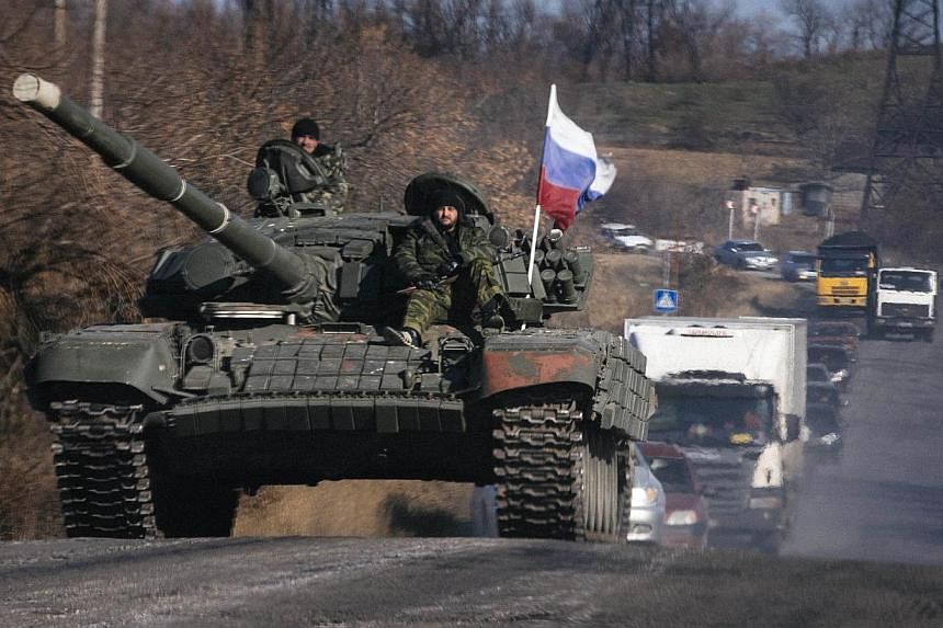 Pro-Russian separatists ride on top of a tank near the town of Krasnyi Luch in Lugansk region, eastern Ukraine, on Oct 28, 2014.&nbsp;More than 100 besieged Ukrainian soldiers, surrounded for nearly a fortnight at their checkpoint near Lugansk, were 