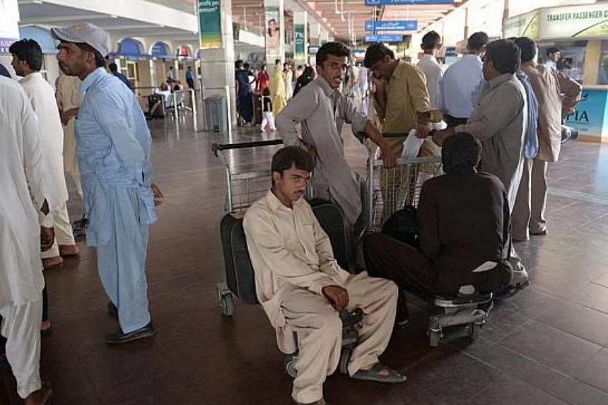 Passengers waiting at the Benazir Bhutto International Airport in Islamabad, Pakistan on Jun 9, 2014. -- PHOTO: AFP