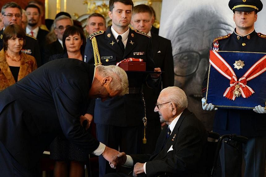 Czech President Milos Zeman (left) greets Sir Nicholas Winton at Prague Castle after he received the Order of the White Lion on Oct 28, 2014. Sir Nicholas, who saved hundreds of Jewish children in Prague from the Nazis in the run-up to World War II, 