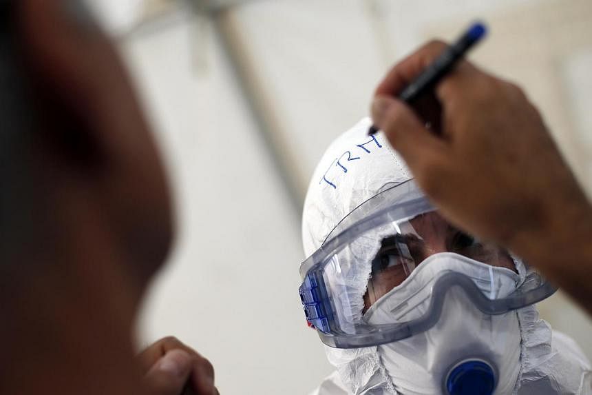 A worker has her name written on her protective suit during an Ebola training session held by Spain's Red Cross in Madrid on Oct 29, 2014. -- PHOTO: REUTERS