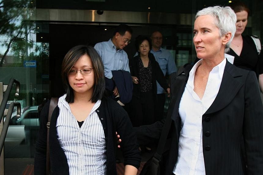 Widow Michelle Lee leaves court with her legal counsel on Dec 1, 2008.&nbsp;Ms Lee who witnessed her husband reverse his car over the edge of a second-storey carpark in Sydney and plunge to his death, has been awarded A$2.6 million (S$2.94 million) d