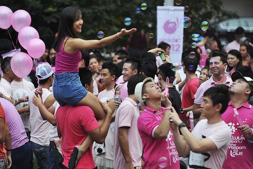 Participants at Pink Dot 2012 blowing bubbles at Hong Lim Park on June 30, 2012.&nbsp;-- PHOTO: ST FILE