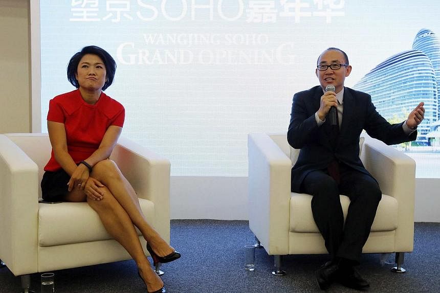 SOHO China chairman Pan Shiyi (right) with CEO Zhang Xin during a news conference to mark the opening of Wangjing SOHO, in Beijing on Sept 20, 2014. -- PHOTO: REUTERS