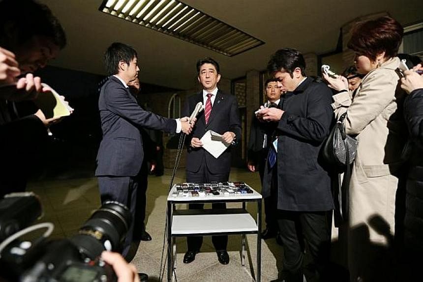 Japanese Prime Minister Shinzo Abe speaks to reporters at his official residence in Tokyo on Oct 30, 2014 after he met with a Japanese envoy who visited North Korea. Junichi Ihara, who heads the Japanese foreign ministry's Asian and Oceania Affairs B