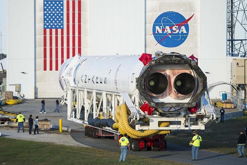 Orbital Sciences Corporation's Antares rocket, with the Cygnus spacecraft onboard, rolls from the Horizontal Integration Facility to launch Pad-0A at Nasa's Wallops Flight Facility in Virginia, in this Oct 24, 2014 handout photo provided by Nasa. Aut