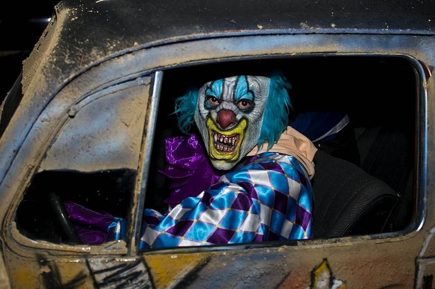 A file picture taken on Oct 31, 2012 shows a man dressed up as a clown driving a car on Halloween night in Mexico city. Complaints have poured in recently over "armed clowns" wreaking havoc in various parts of France - some carrying pistols, knives o