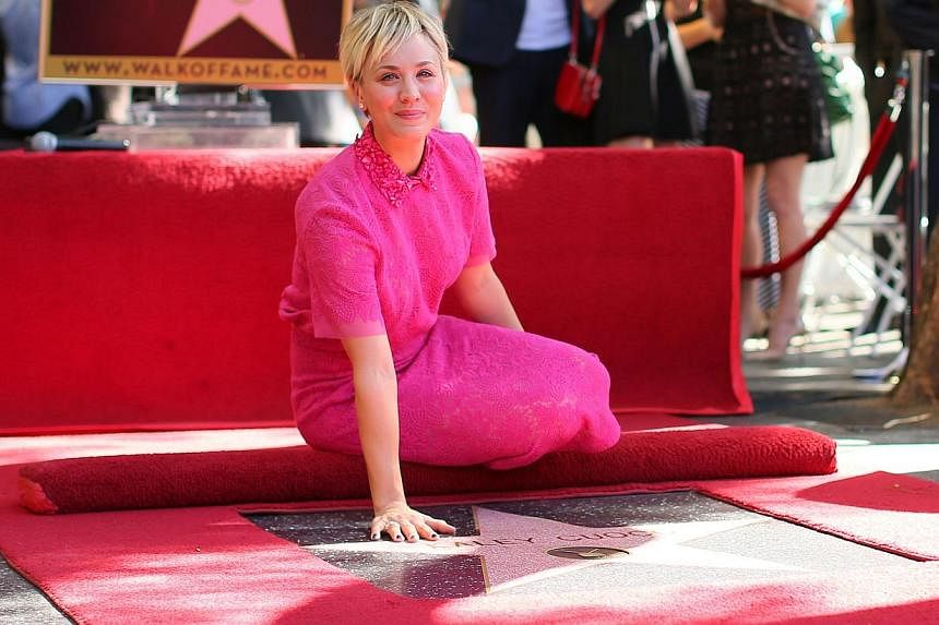 Actress Kaley Cuoco poses with her star on the Hollywood Walk of Fame in Hollywood, California on Oct 29, 2014. -- PHOTO: AFP