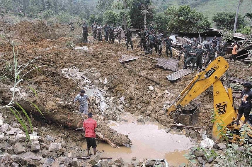 Rescue teams from the Sri Lankan military engage in rescue operation work at the site of a landslide at the Koslanda tea plantation in Badulla on Oct 29, 2014. -- PHOTO: REUTERS