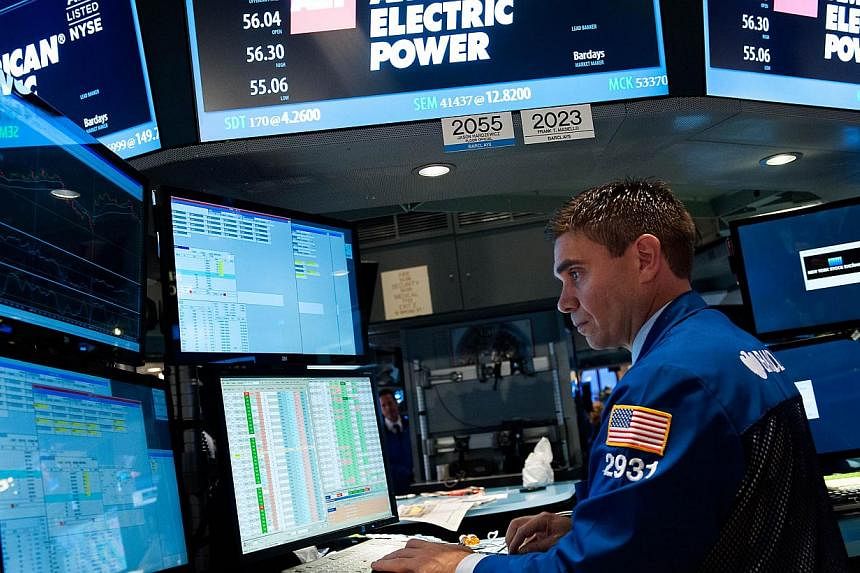 Wall Street stocks finished lower Wednesday after the US Federal Reserve ended its quantitative easing stimulus programme, but said it would continue to keep its benchmark interest rate low. -- PHOTO: AFP