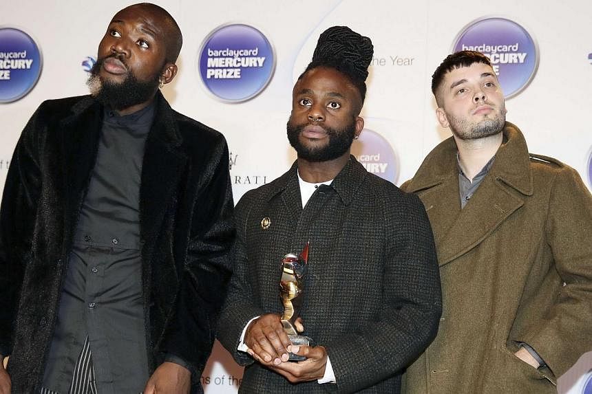 Young Fathers pose with their trophy after winning the 2014 Mercury Prize in London on October 29, 2014. -- PHOTO: REUTERS