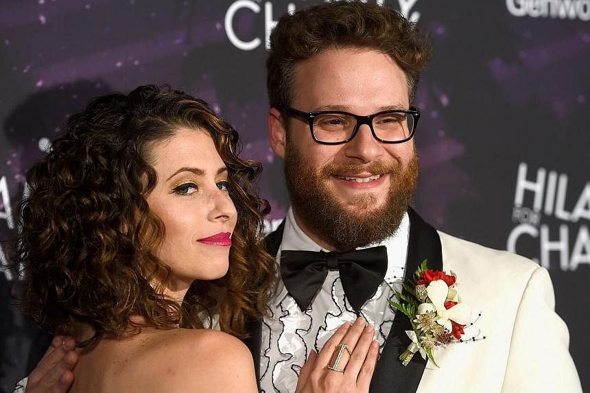 Actor Seth Rogen and wife Lauren Miller arrive at the Hollywood Palladium in California on Oct 17, 2014. -- PHOTO: REUTERS