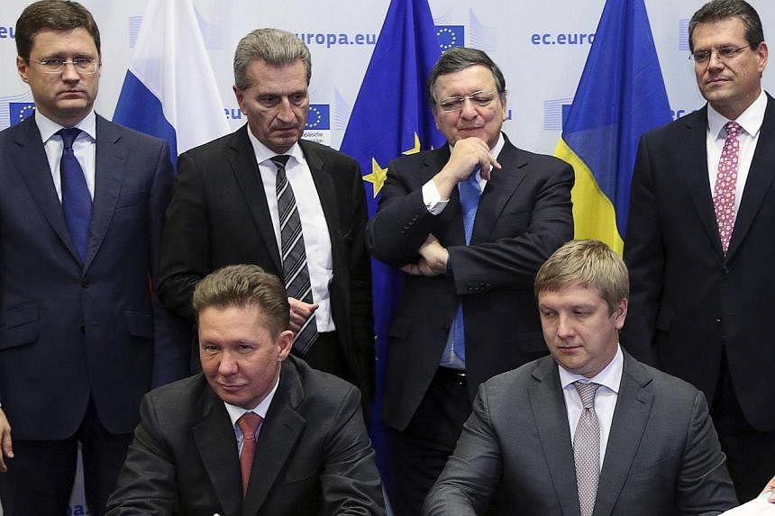 (Front row, from left) Gazprom CEO Alexei Miller and Ukrainian state gas company Naftogaz CEO Andriy Kobolev attend a signing ceremony after gas talks between the European Union, Russia and Ukraine at the European Commission headquarters in Brussels 