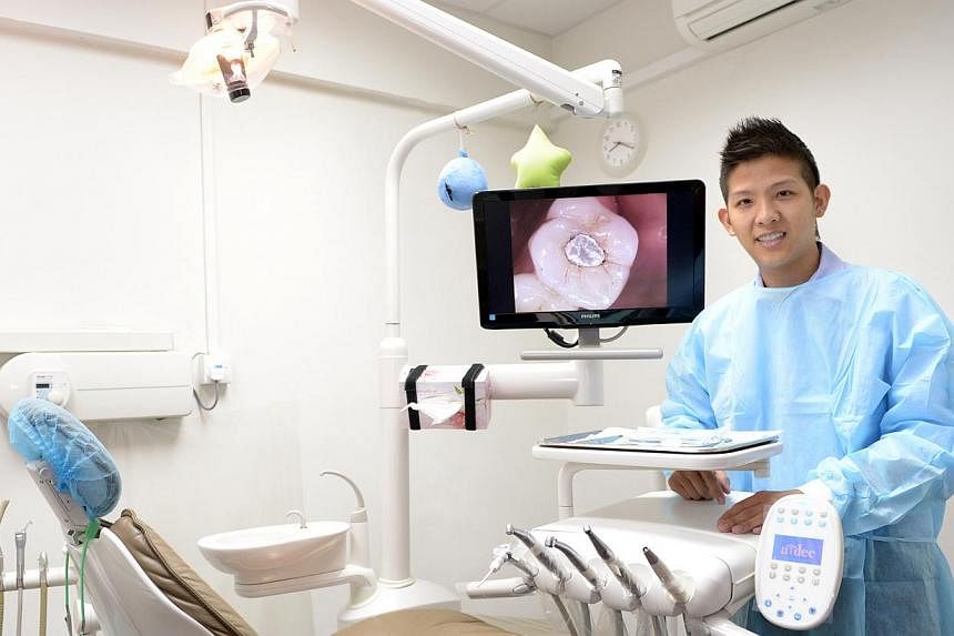Dr Anthony Tay at his dental clinic on Oct 30, 2014. -- ST PHOTO:&nbsp;LIM SIN THAI