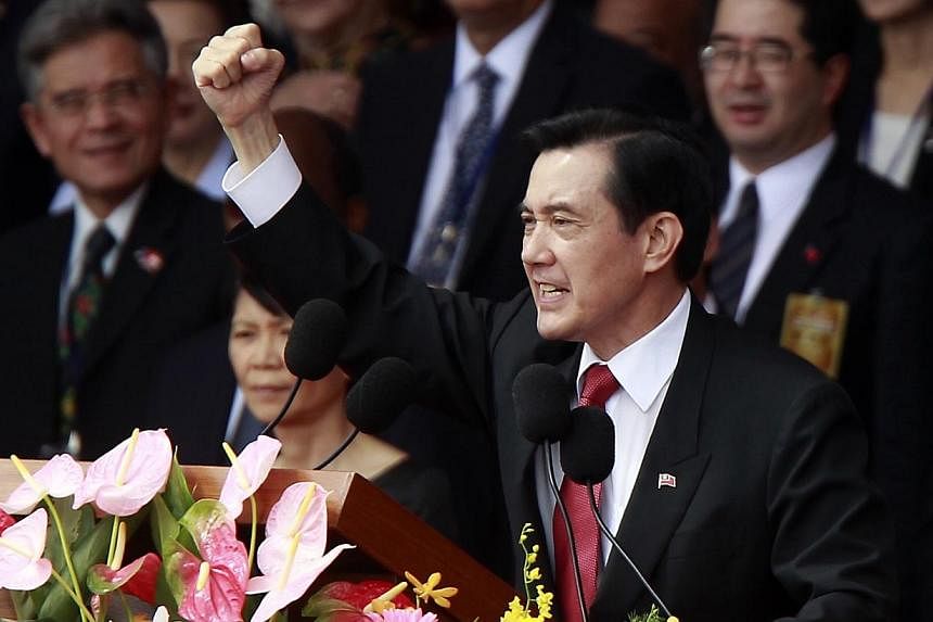 Taiwan's President Ma Ying-jeou raises his fist after giving a speech during National Day celebrations in front of the presidential office in Taipei on Oct 10, 2014.&nbsp;A Taiwanese politician with close ties with the president was sentenced to 10 y