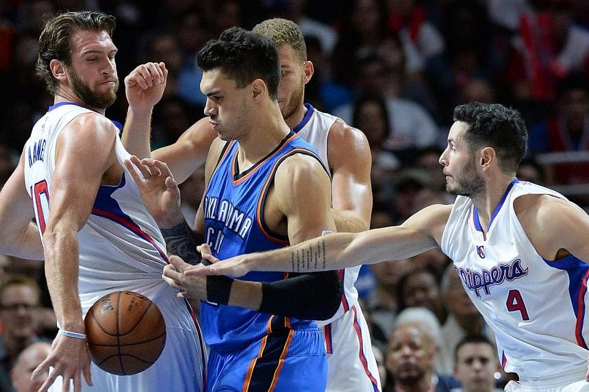 Los Angeles Clippers forward Spencer Hawes (10), guard J.J. Redick (4) and Oklahoma City Thunder center Steven Adams (12) go for the ball in the second half of the game at Staples Center. Clippers won 93-90. It was not pretty but the Los Angeles Clip