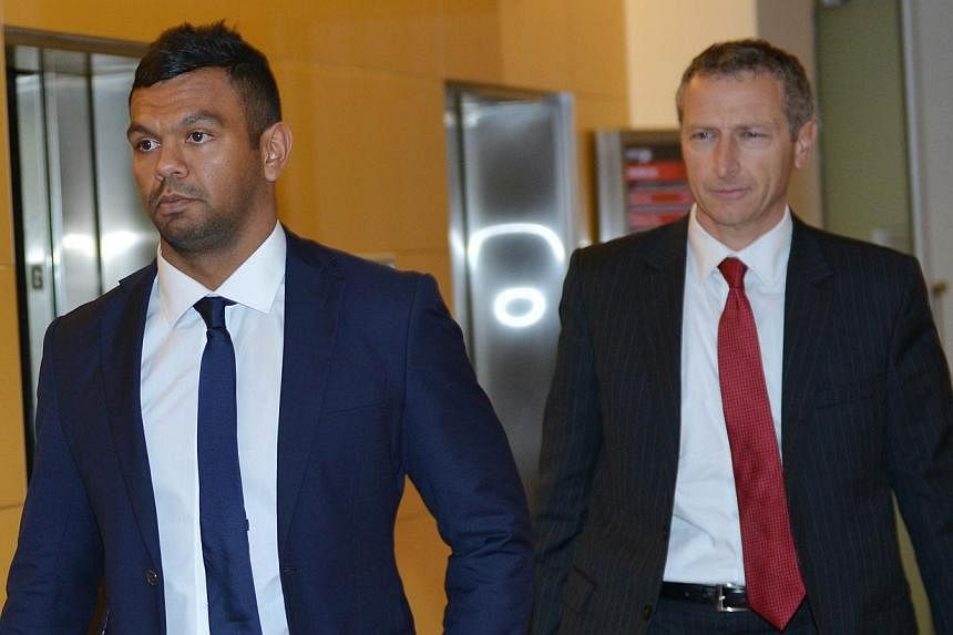 Wallabies rugby union player Kurtley Beale (left) arrives at the Australian Rugby Union (ARU) headquarters in Sydney for a ARU code of conduct hearing on Oct 24, 2014.&nbsp;Troubled Australia back Kurtley Beale has been issued with a last-chance warn