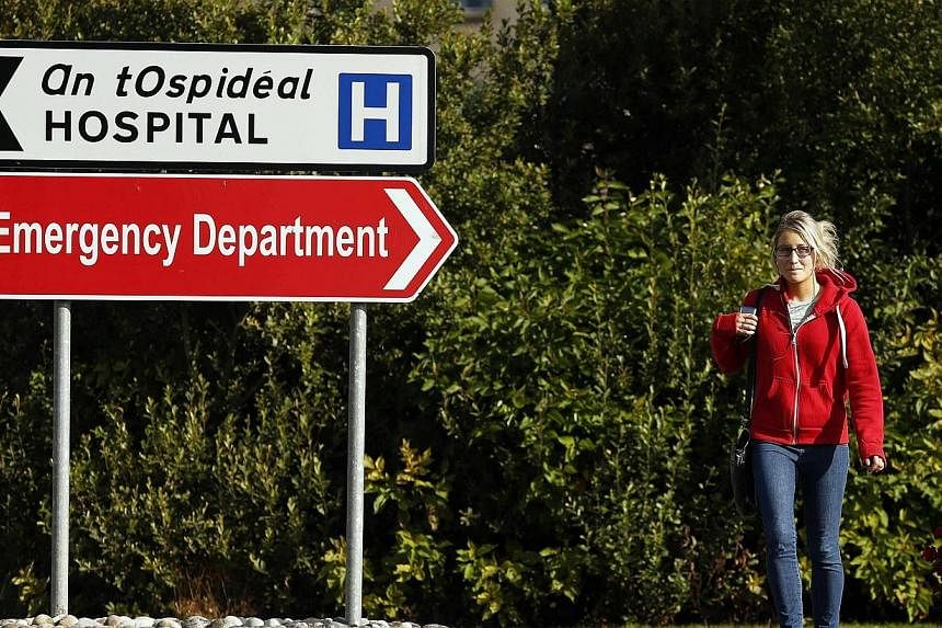 A woman walks past Letterkenny General Hospital in Donegal, Ireland on Aug 22, 2014.&nbsp;An Italian man who joked about having Ebola which caused a Aer Lingus plane to be put on lockdown at the airport has been ordered on Friday to donate 2,500 euro