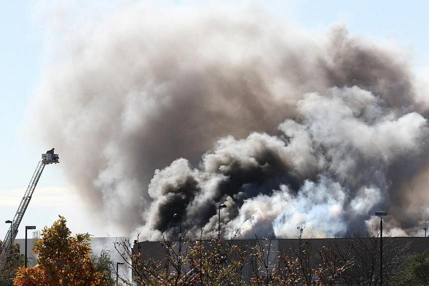 Smoke billows from a building at at Mid-Continent Airport shortly after a twin-turbo airplane crashed into a building, killing several people, including the pilot in Wichita, Kansas on Oct 30, 2014. -- PHOTO: REUTERS