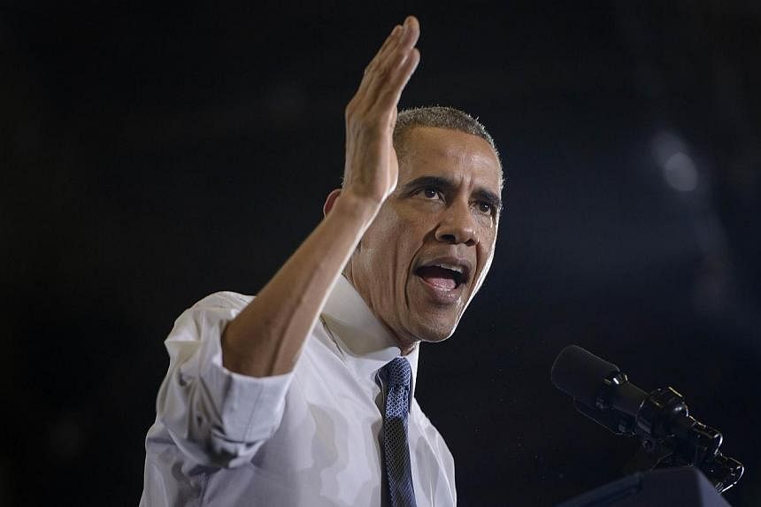 US President Barack Obama addresses a rally at the Portland Expo in Portland, Maine on Oct 30, 2014. -- PHOTO: AFP
