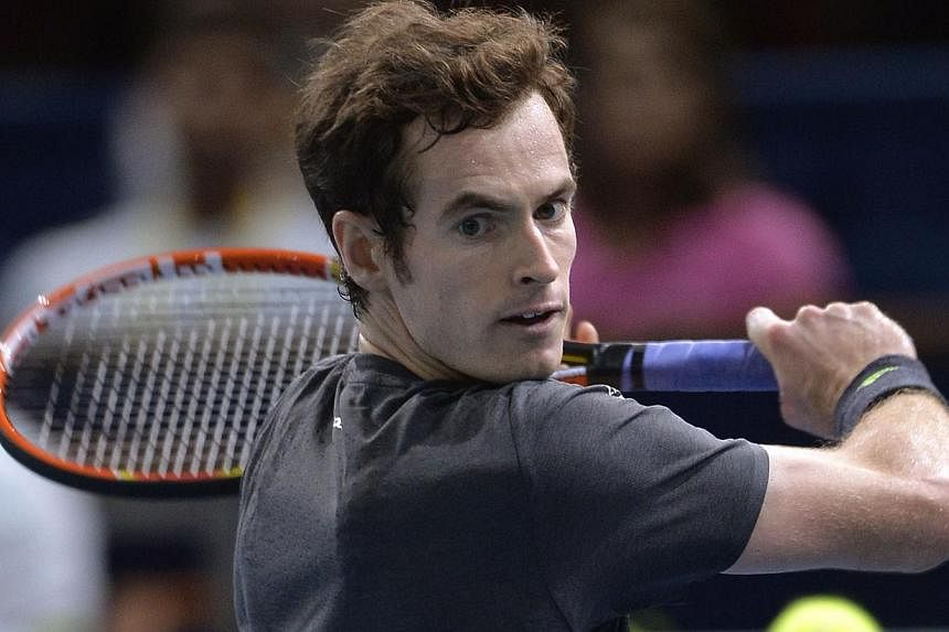 Britain's Andy Murray returns a ball to Bulgaria's Grigor Dimitrov during the third round match at the ATP World Tour Masters 1000 indoor tennis tournament on Oct 30, 2014 at the Bercy Palais-Omnisport in Paris. -- PHOTO: AFP