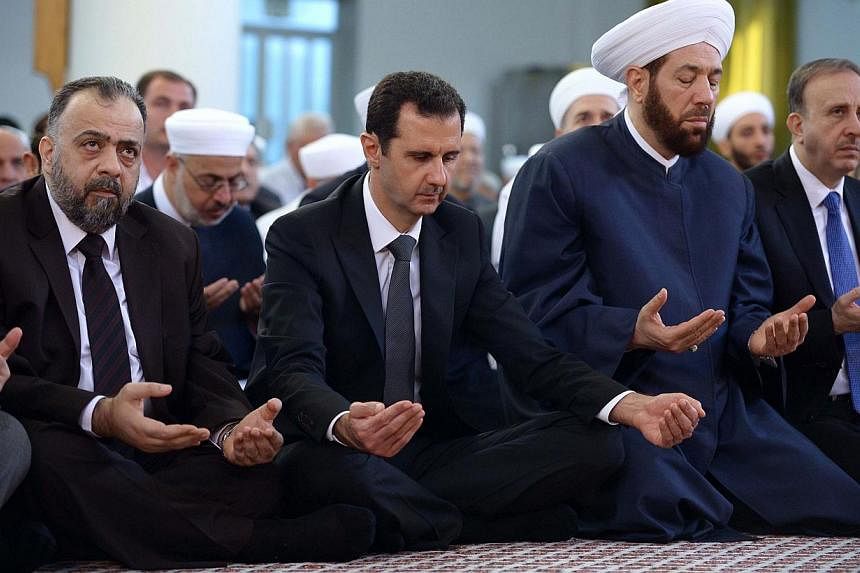 Syria's President Bashar al-Assad (second left) attends Eid al-Adha prayers at al-Nu'man bin Bashir mosque in Damascus Oct 4, 2014, in this handout photograph released by Syria's national news agency Sana. Pentagon chief Chuck Hagel acknowledged on T