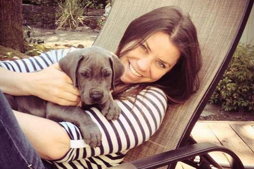 A 2013 photo obtained on Oct 30, 2014 shows Brittany Maynard and her Great Dane puppy Charlie. The&nbsp;American 29-year-old with terminal brain cancer whose video about planning to kill herself on Nov 1 went viral, says she will hold on a little lon