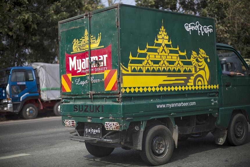 A Myanmar Beer truck, a brand of Myanmar Brewery Ltd., drives along a road in Yangon, Myanmar, on Monday, Jan 14, 2013.&nbsp;Fraser and Neave has lost a legal spat with a joint venture partner that has been trying to force F&amp;N to sell out of Myan