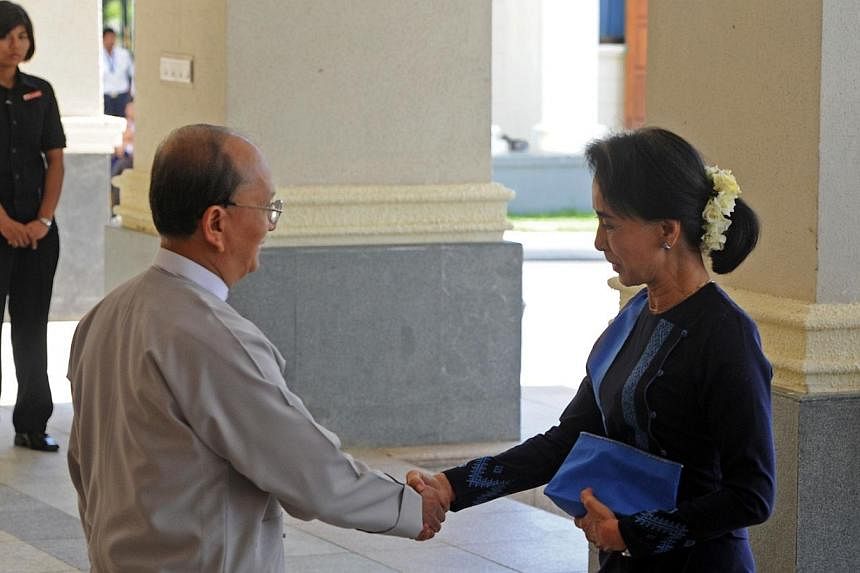 Myanmar President Thein Sein shaking hands with Ms Aung San Suu Kyi, chairman of the National League for Democracy (NLD) and Lower House member of Parliament prior to their meeting in Naypyidaw on October 31, 2014. Mr Thein Sein opened unprecedented 