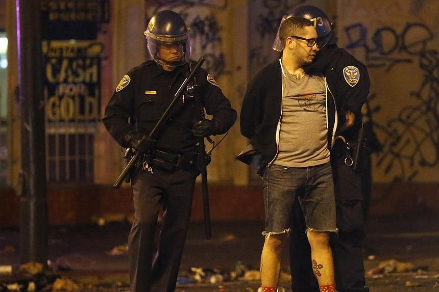 A man is being detained by the police after a street celebration in San Francisco, California on Oct 29, 2014. -- PHOTO: REUTERS